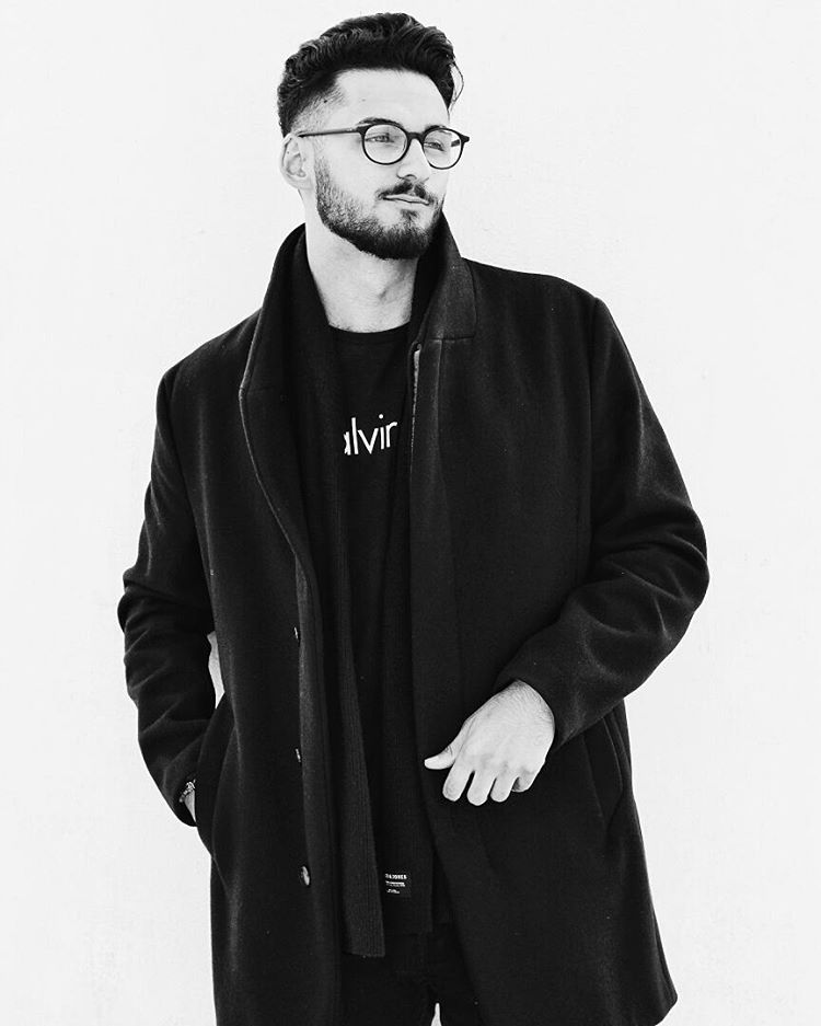 Black and white portrait of a man in a coat