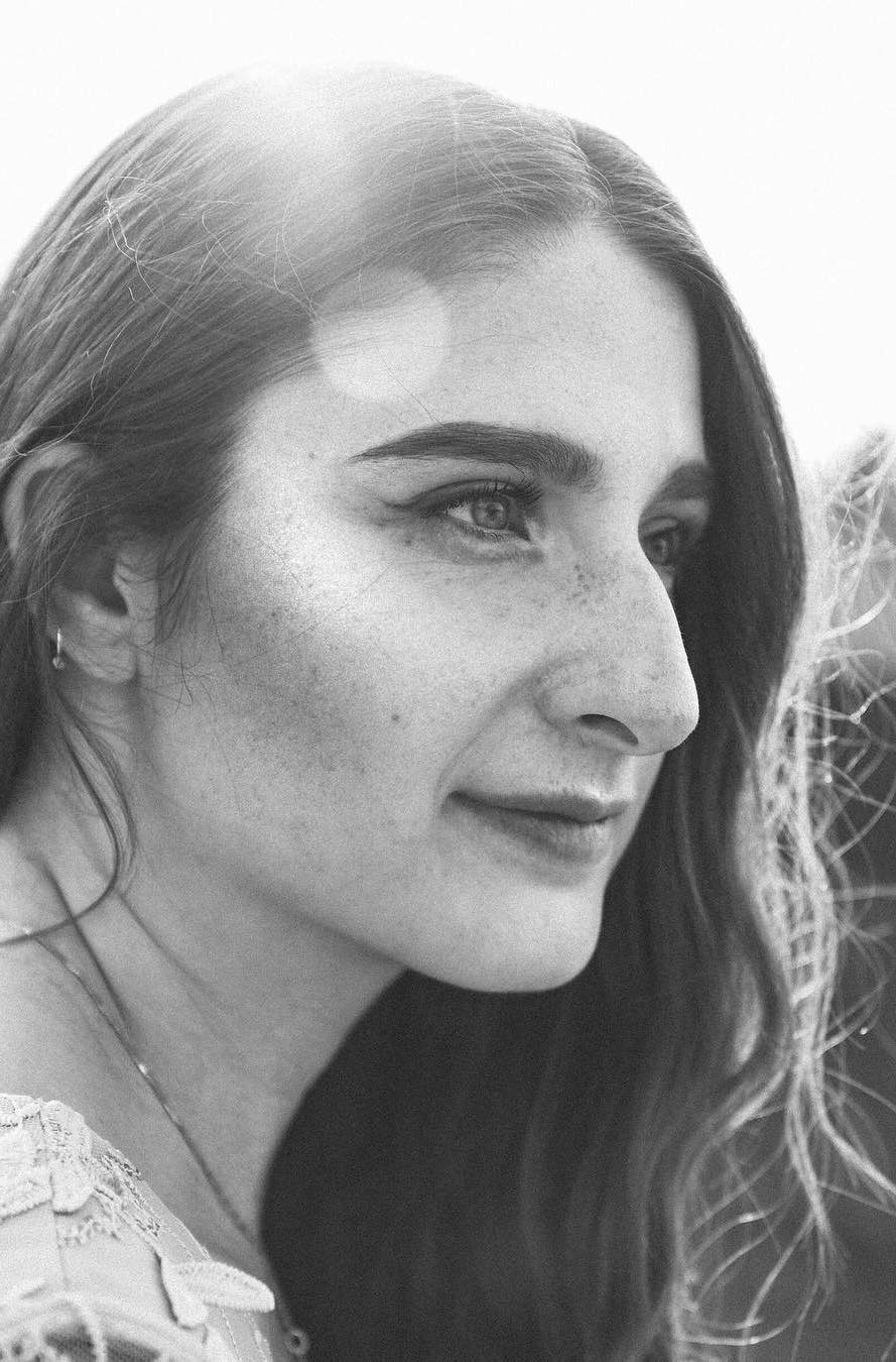 Black and white portrait of a woman with freckles in profile